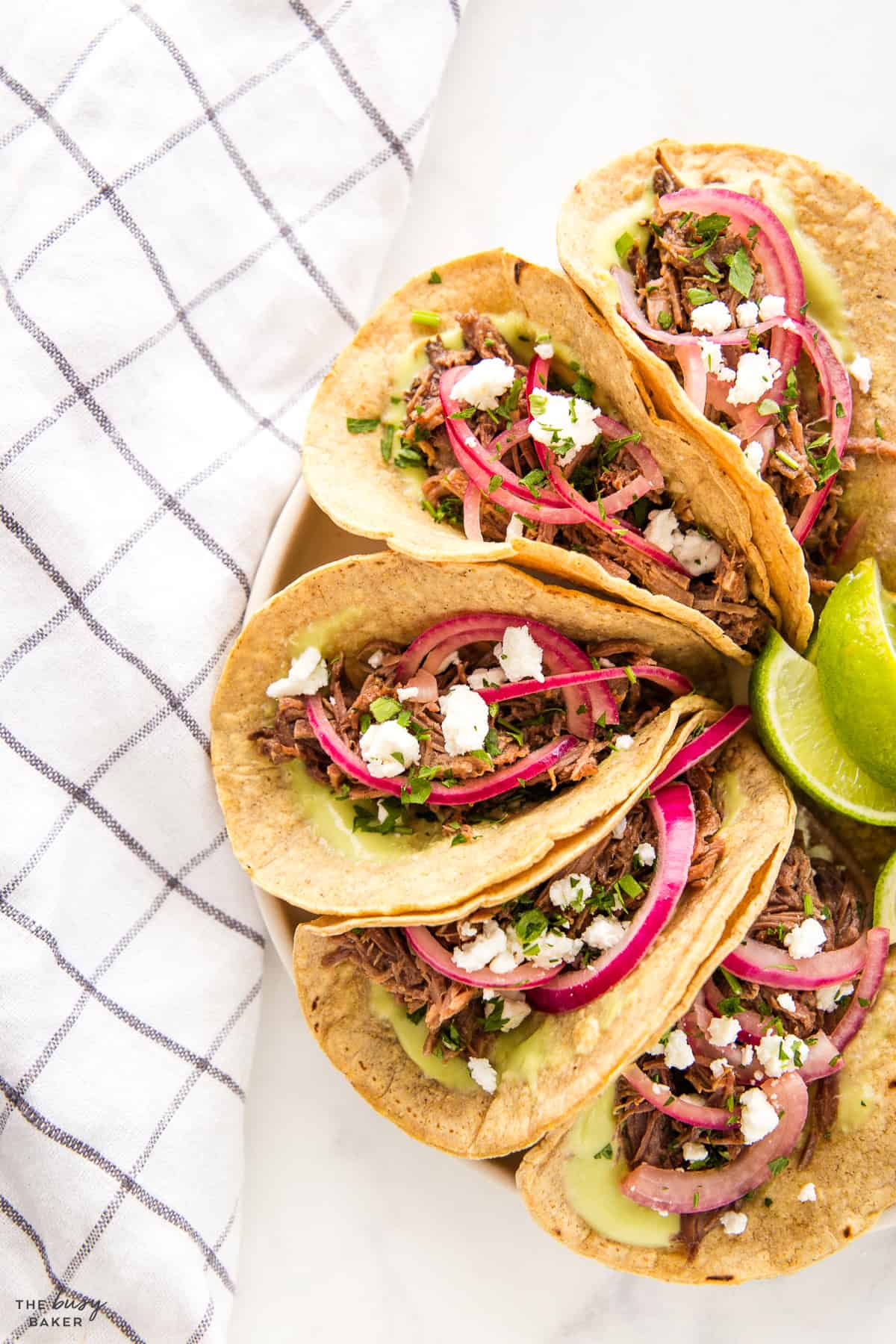 shredded barbacoa beef tacos with pickled onions