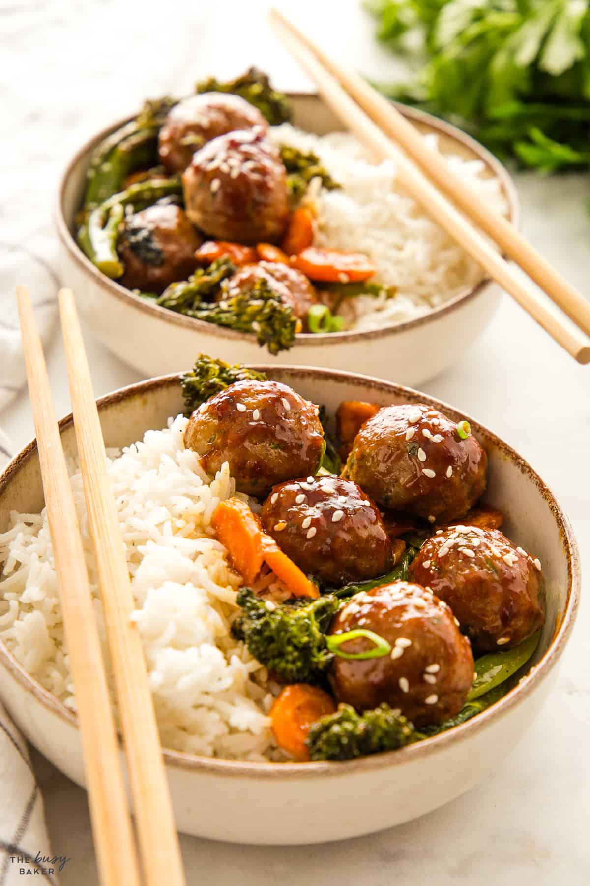 bowls of teriyaki meatballs with veggies and rice