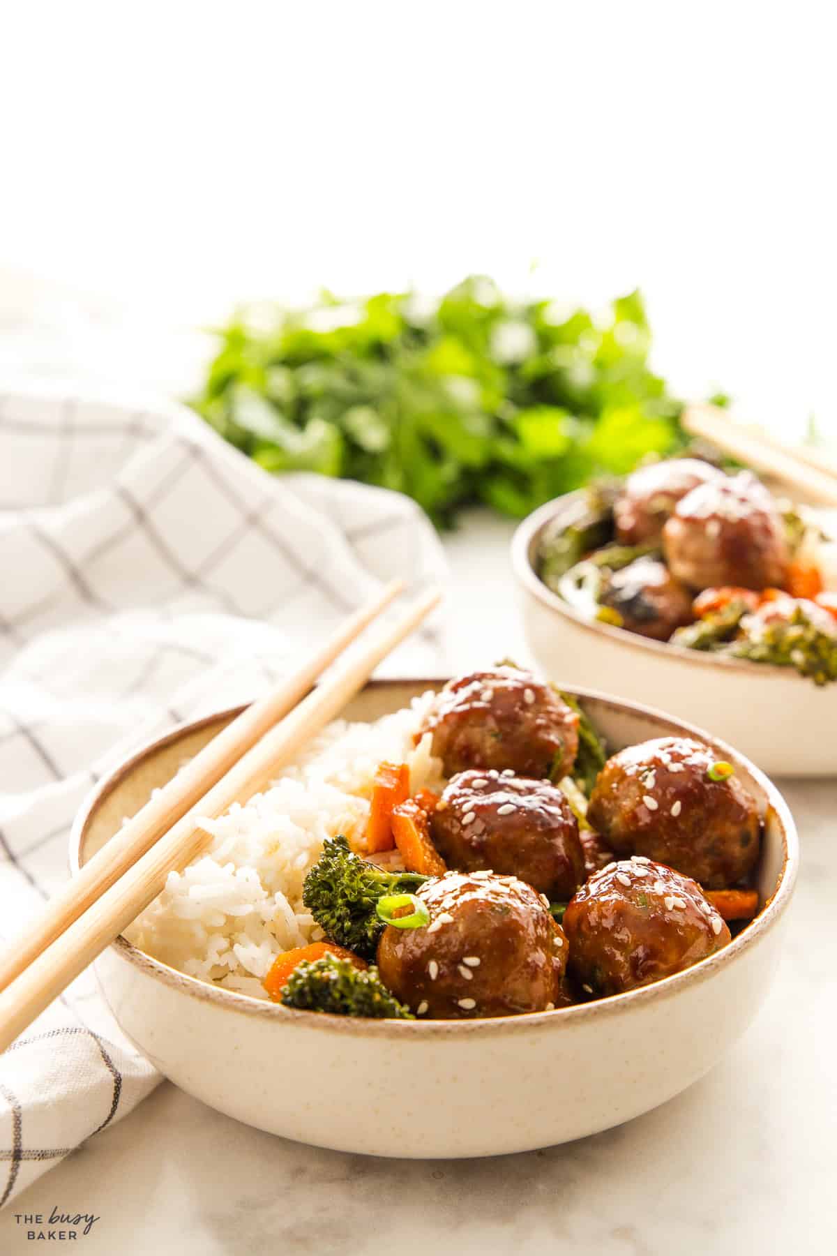 dinner in a bowl with meatballs, veggies and rice