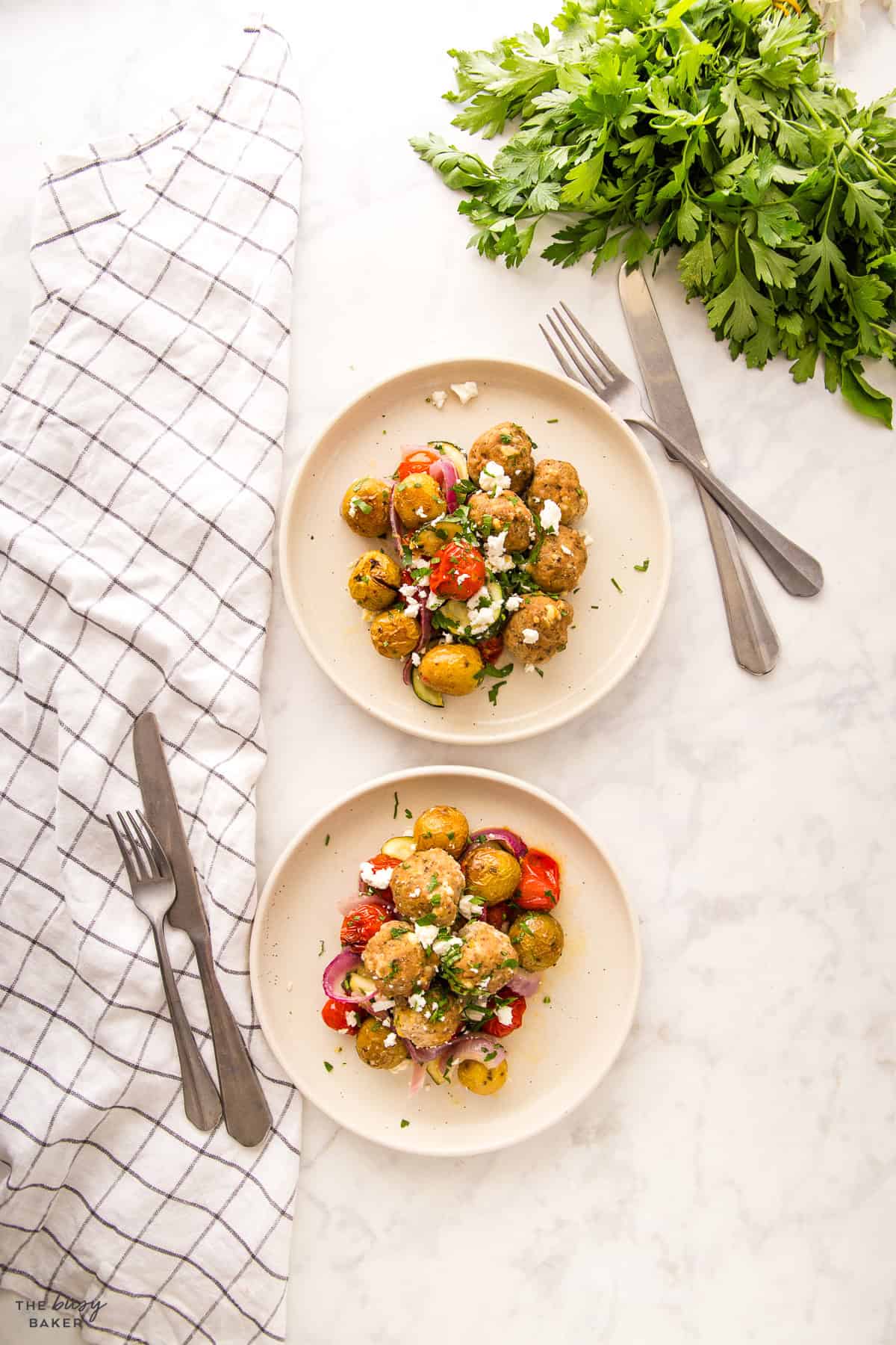 overhead image: 2 plates of meatballs and roasted veggies