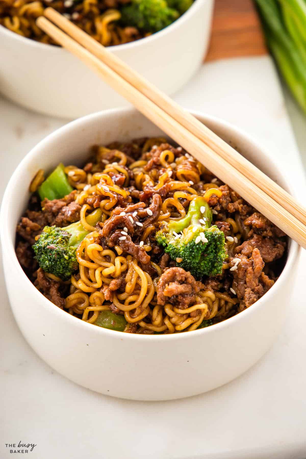 bowl of beef ramen with broccoli and chopsticks