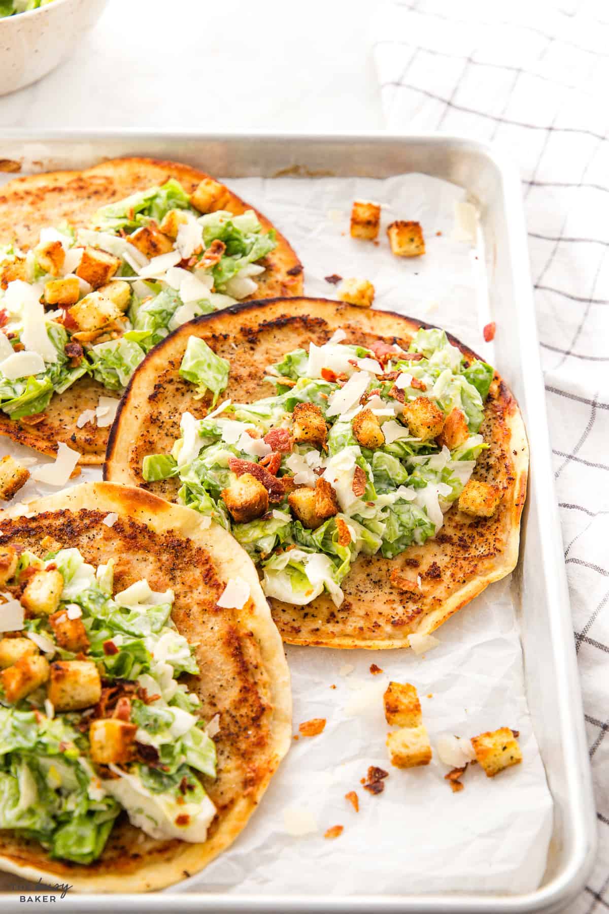 smash tacos on a sheet pan with caesar salad