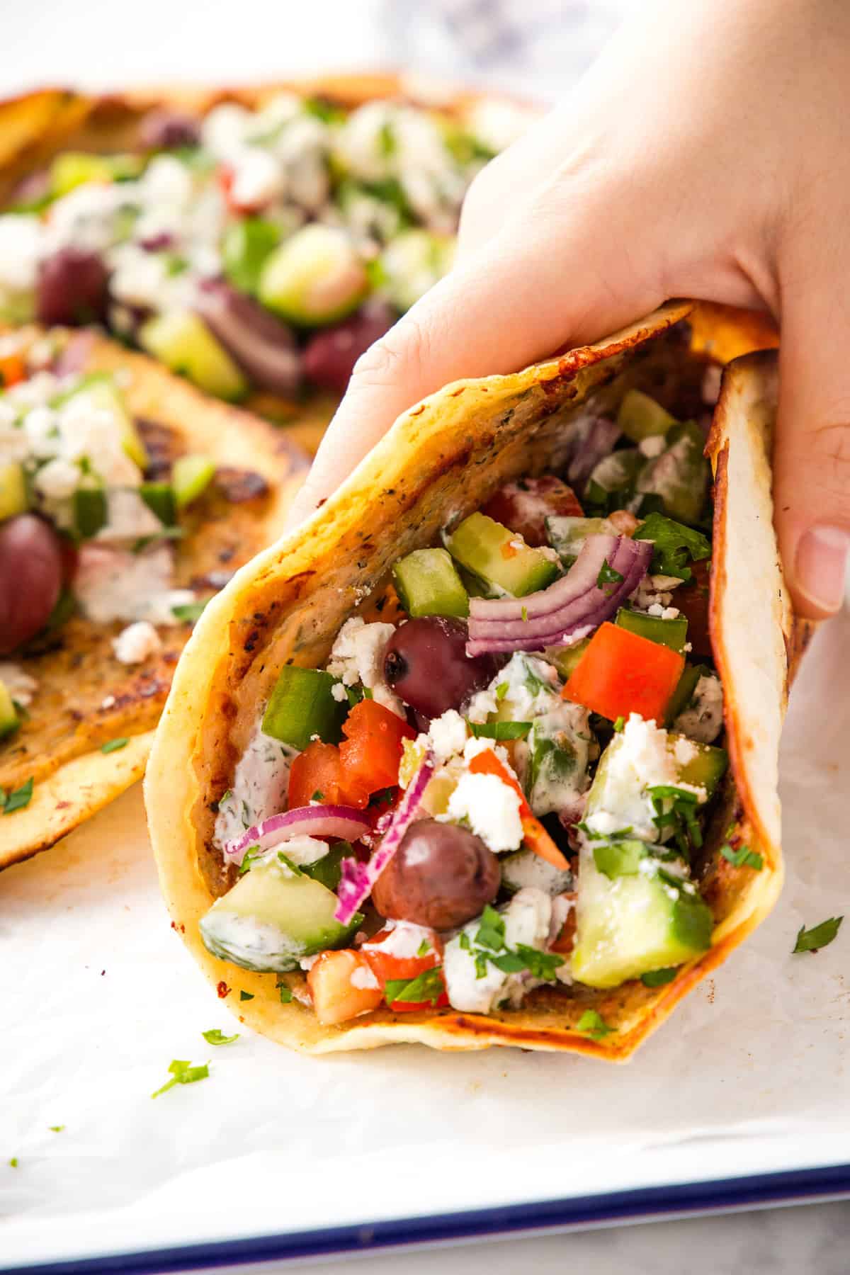 hand holding a greek smash taco