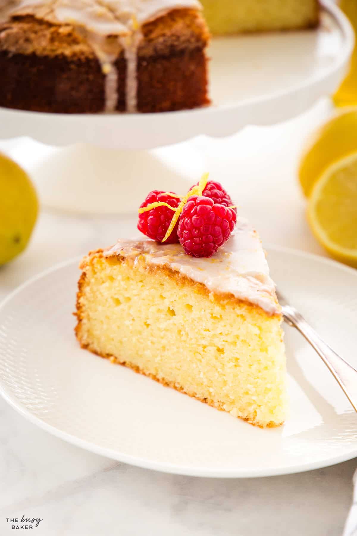 slice of tender lemon olive oil cake on a white plate
