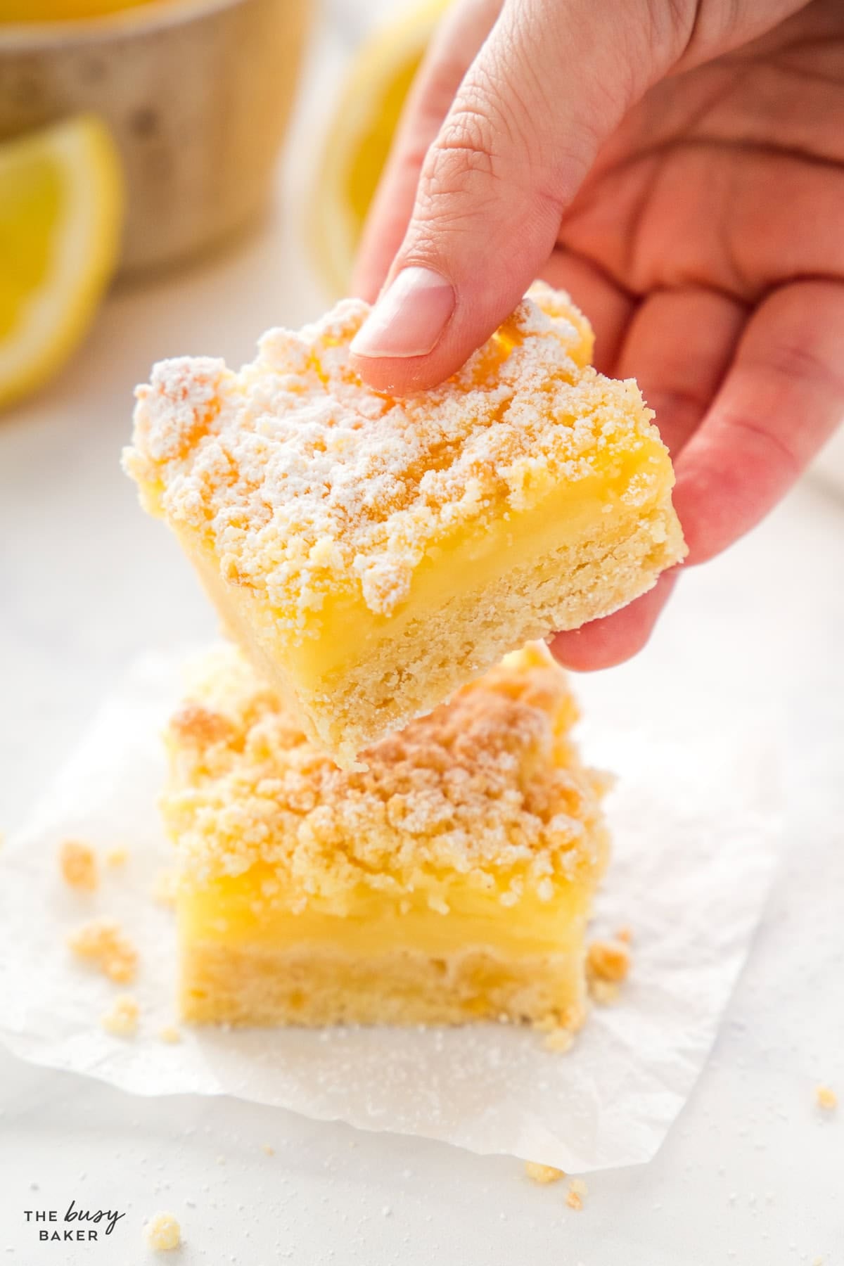 hand holding lemon bars 