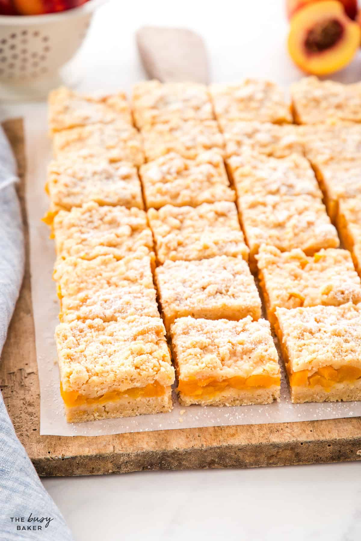 peach crumb bars sliced on a wooden board