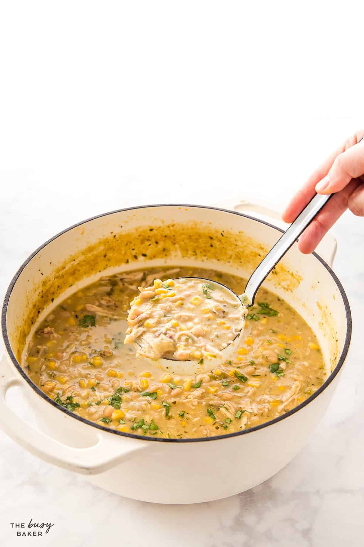 pot of white chicken chili with a white ladle