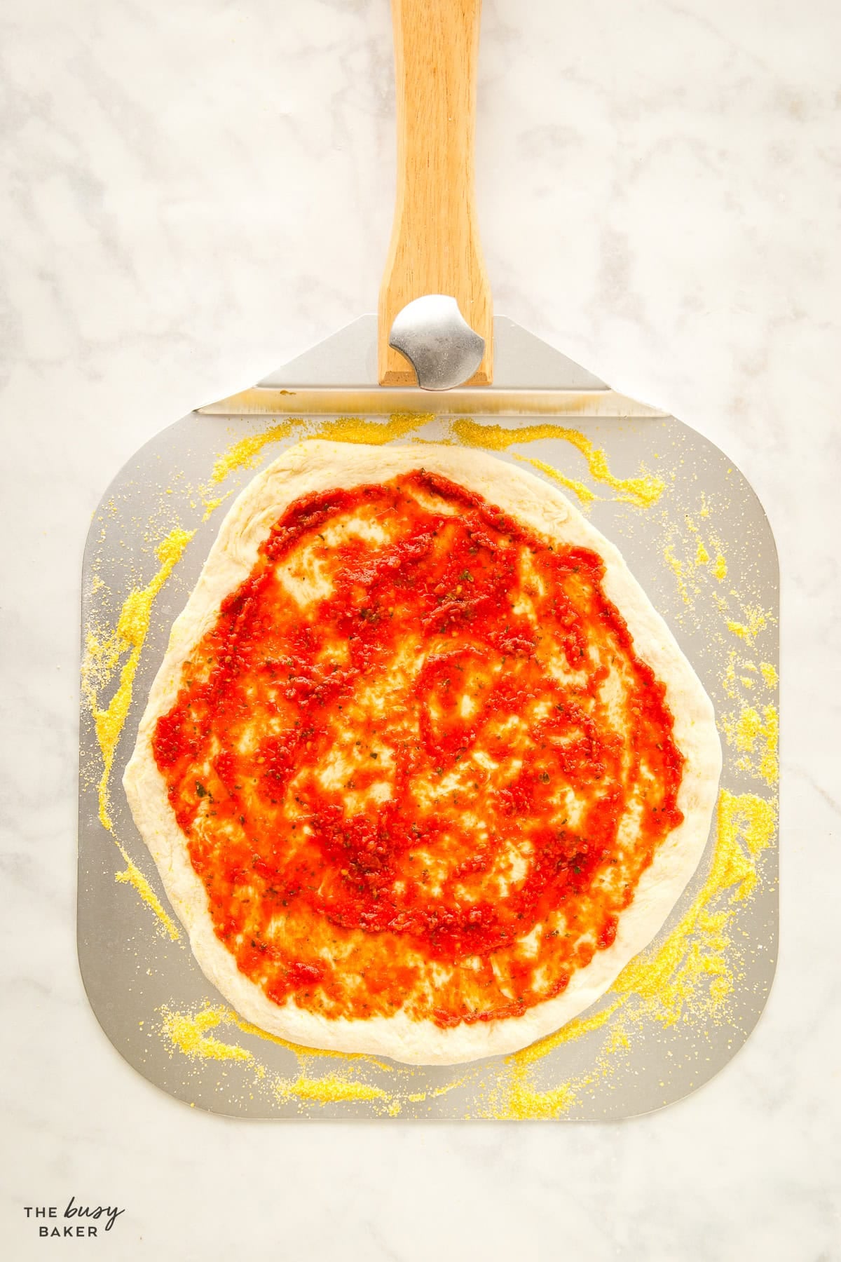 homemade pizza sauce spread on a pizza dough