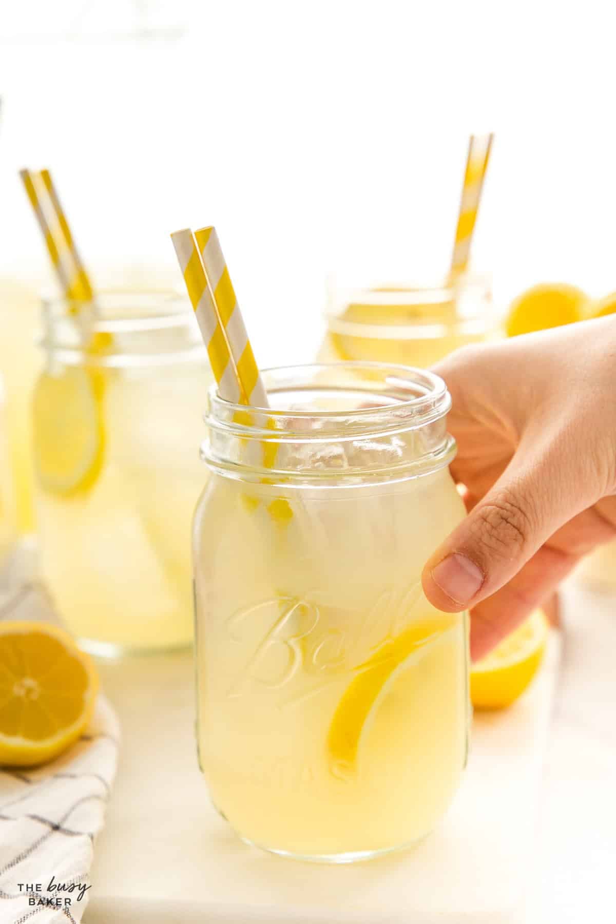 hand holding glass of sugar free lemonade