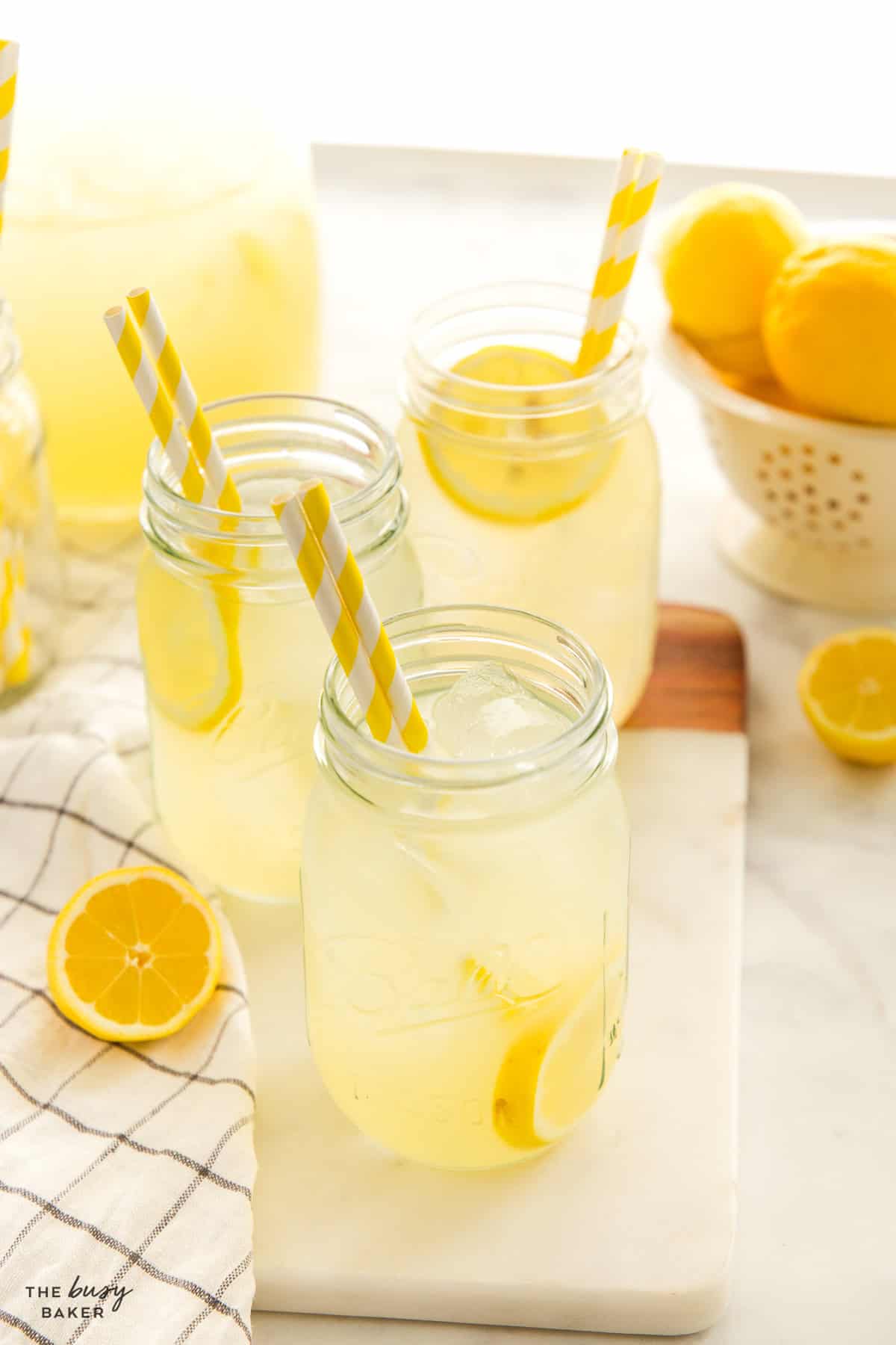 lemonade in mason jars with ice and paper straws