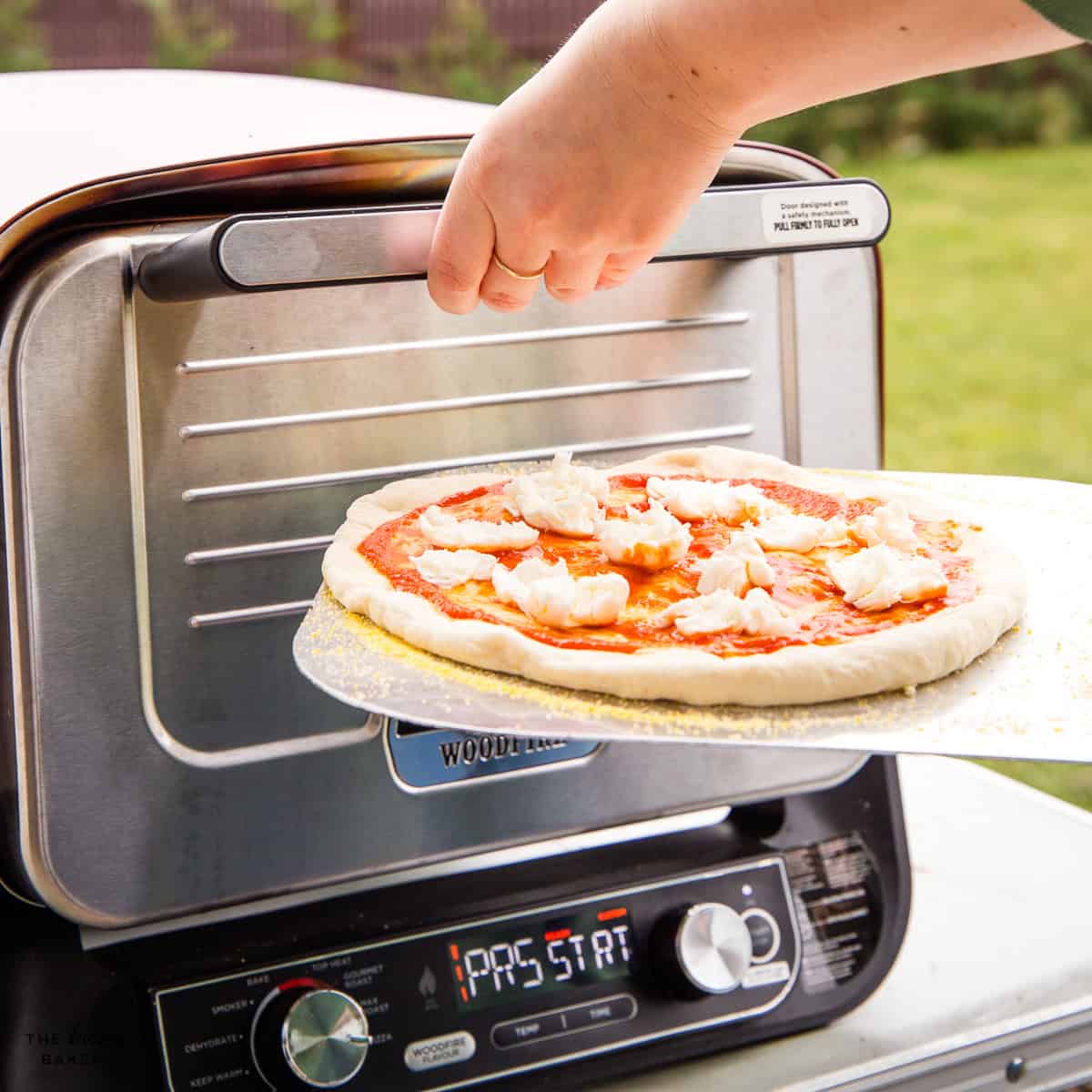 cooking pizza in an outdoor Ninja pizza oven
