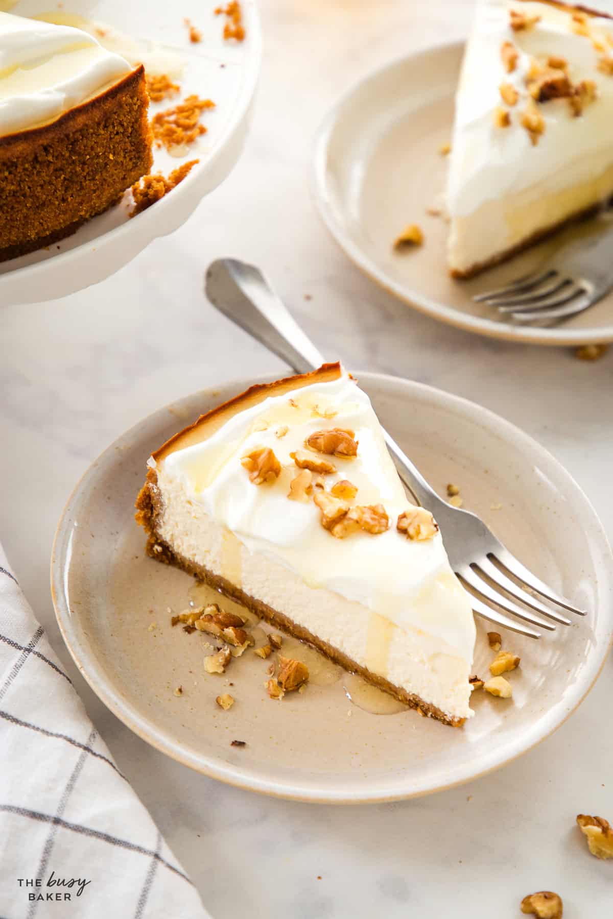 Slice of healthy Greek yogurt cheesecake with honey drizzle and chopped walnuts