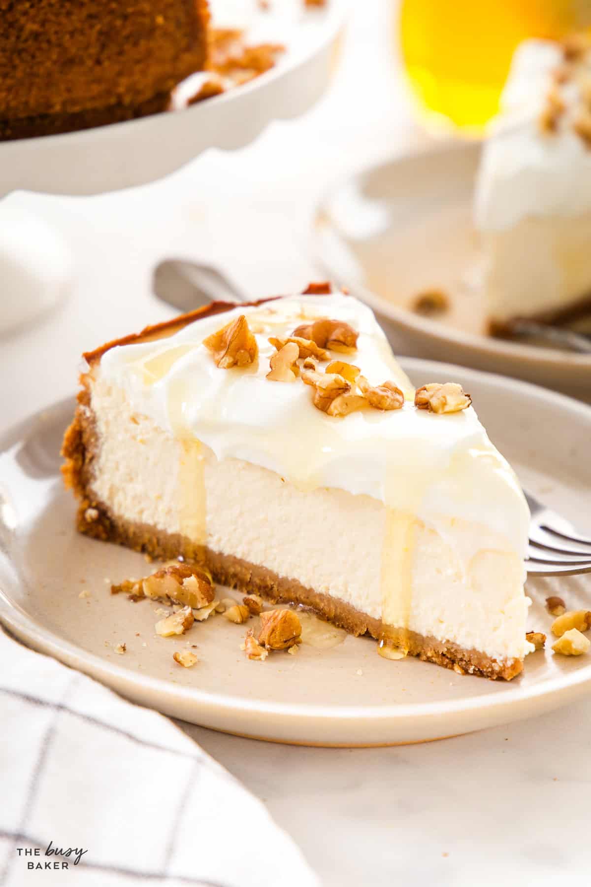 Slice of healthy Greek yogurt cheesecake with honey drizzle and chopped walnuts